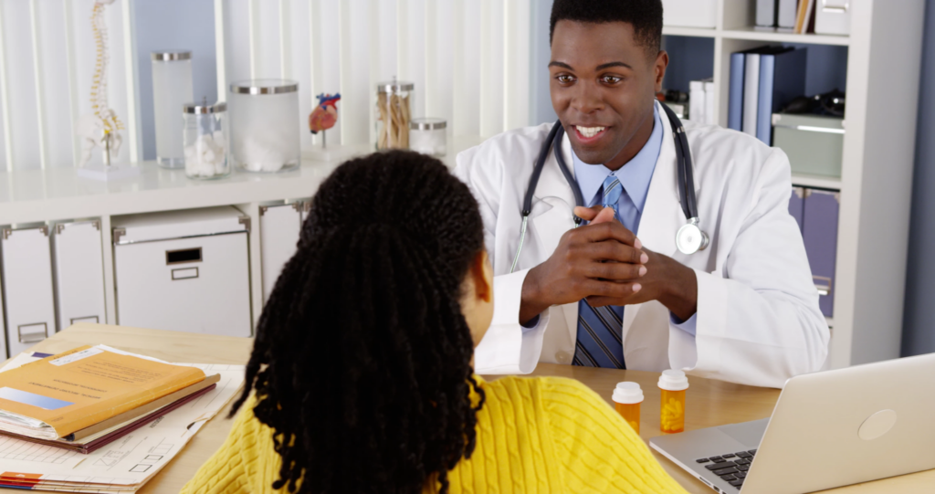 doctor and patient talking with drugs on table